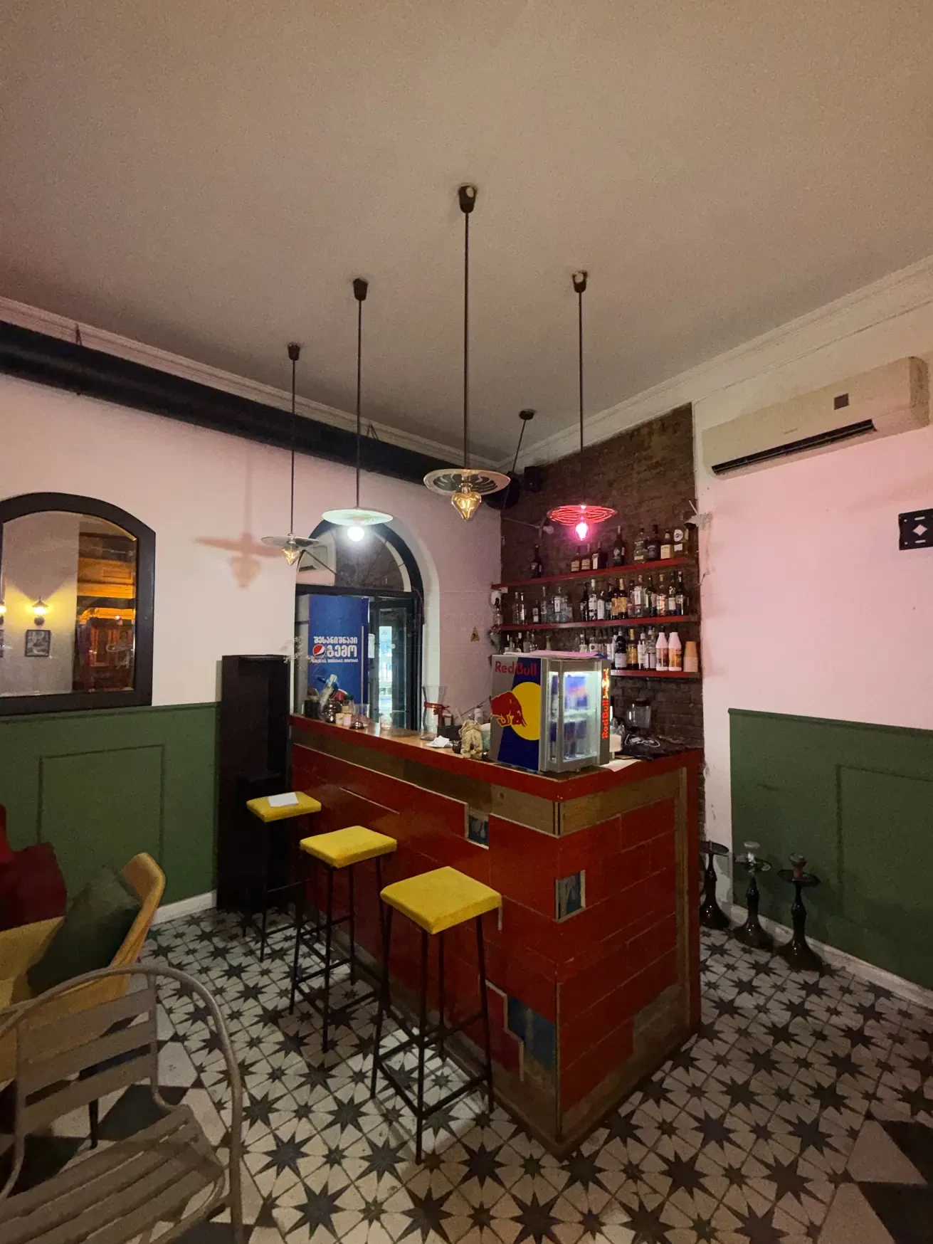 commercial cafe bar space for rent on Aghmashenebeli Avenue 26, Chugureti, Tbilisi — red-tiled bar counter with yellow bar stools