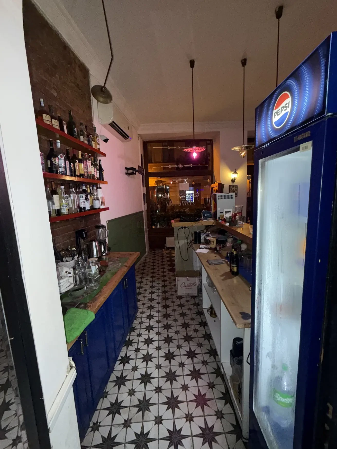 commercial cafe bar space for rent on Aghmashenebeli Avenue 26, Chugureti, Tbilisi — service bar corridor with back-bar shelving and star-tiled floor