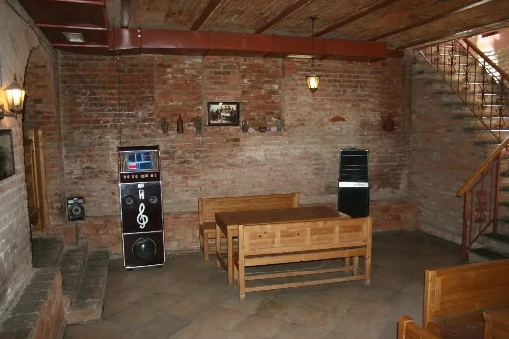 commercial space for rent on Aghmashenebeli Avenue, Chugureti, Tbilisi — vaulted brick main hall with wooden benches and staircase