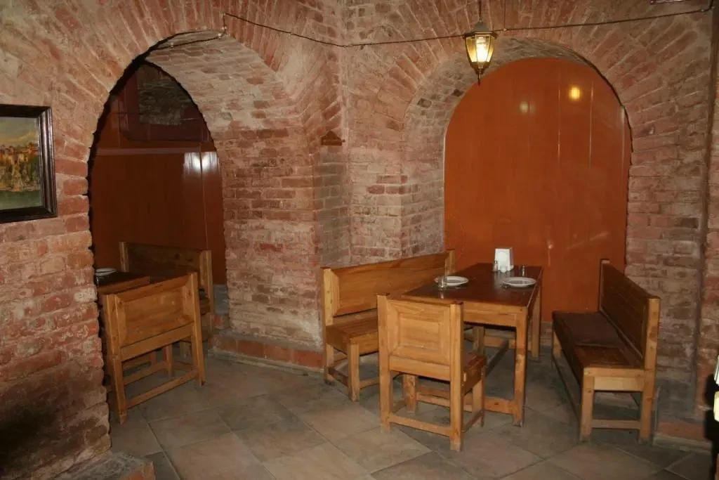 commercial space for rent on Aghmashenebeli Avenue, Chugureti, Tbilisi — arched brick alcove seating area with wooden tables