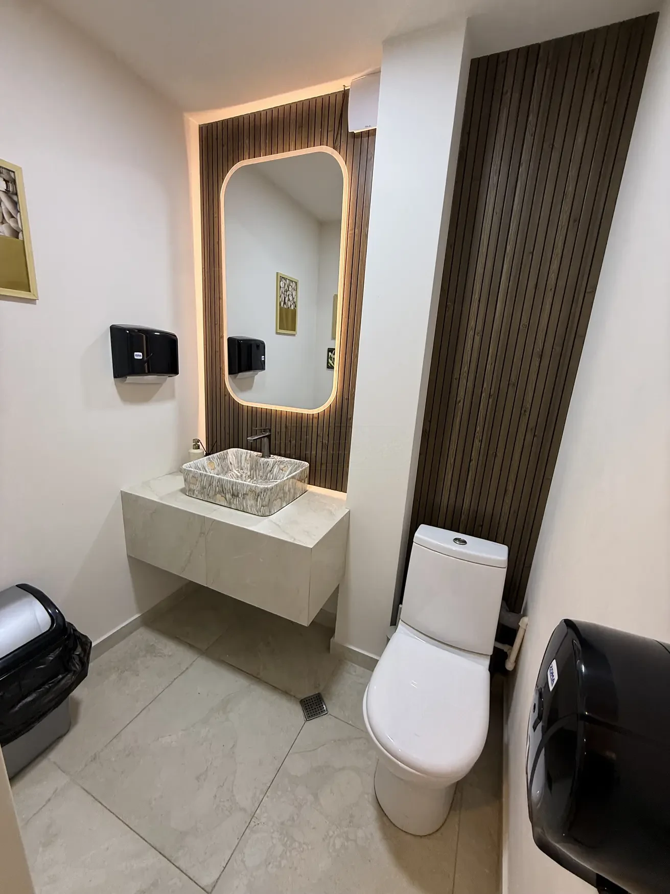 commercial space for rent on Kazbegi Avenue 47b, Saburtalo, Tbilisi — modern WC with backlit mirror and stone basin