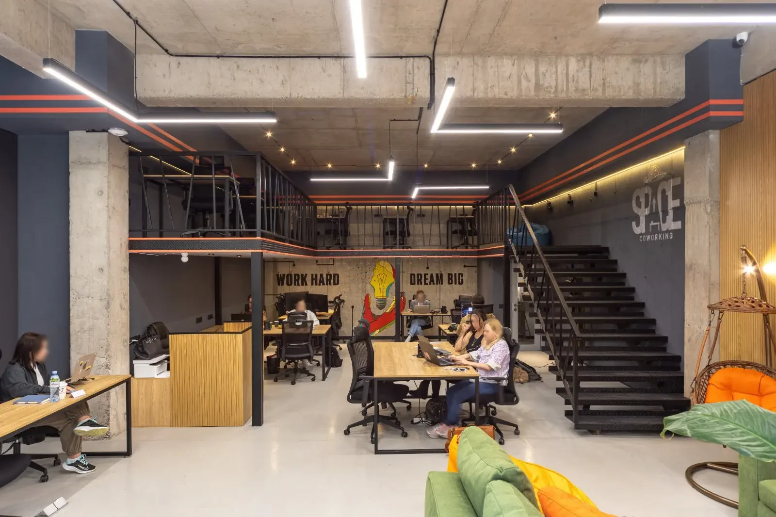 office space for rent on Politkovskaya Street (Jikia), Saburtalo, Tbilisi — main hall with mezzanine and Work Hard Dream Big mural