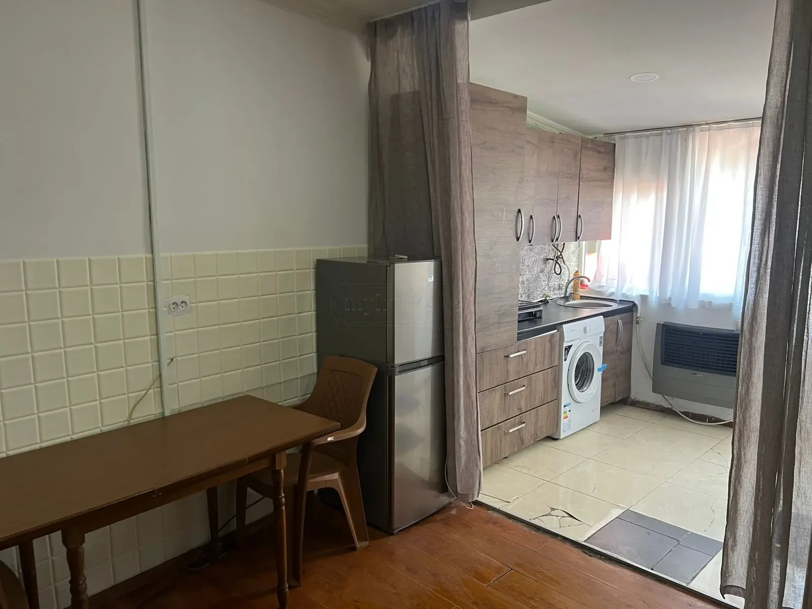 2-room apartment for rent on Javakhishvili Street, Chugureti, Tbilisi — dining area and kitchen with refrigerator