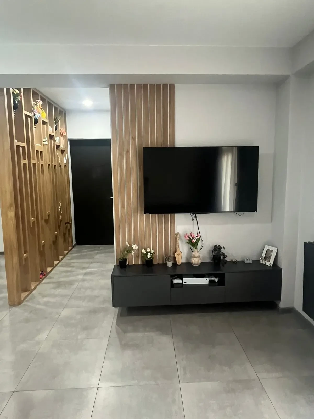 2-room apartment for sale on Marshal Gelovani Avenue, Saburtalo, Tbilisi — living room TV wall and wooden partition to the hallway