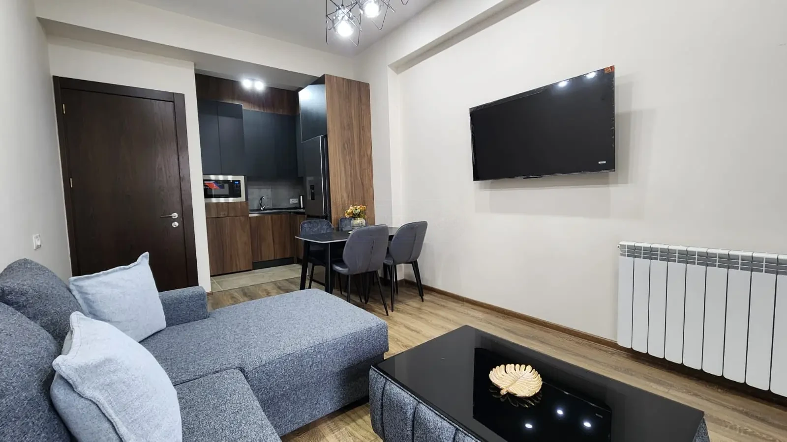 2-room apartment for sale on Pekini Avenue, Saburtalo, Tbilisi — living room toward the open kitchen