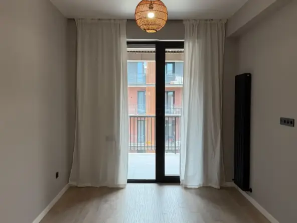 2-room apartment for sale on Permtserta Street, Nutsubidze Plateau, Tbilisi — living room with balcony door