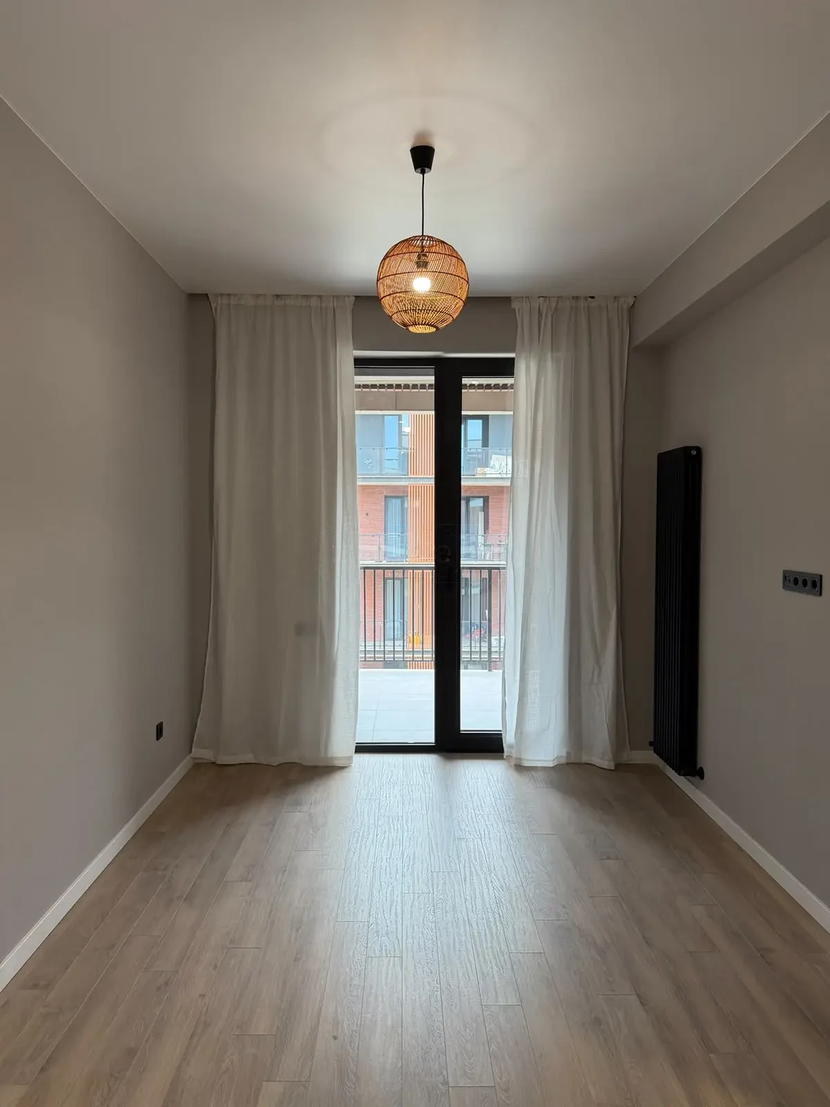 2-room apartment for sale on Permtserta Street, Nutsubidze Plateau, Tbilisi — living room with balcony door