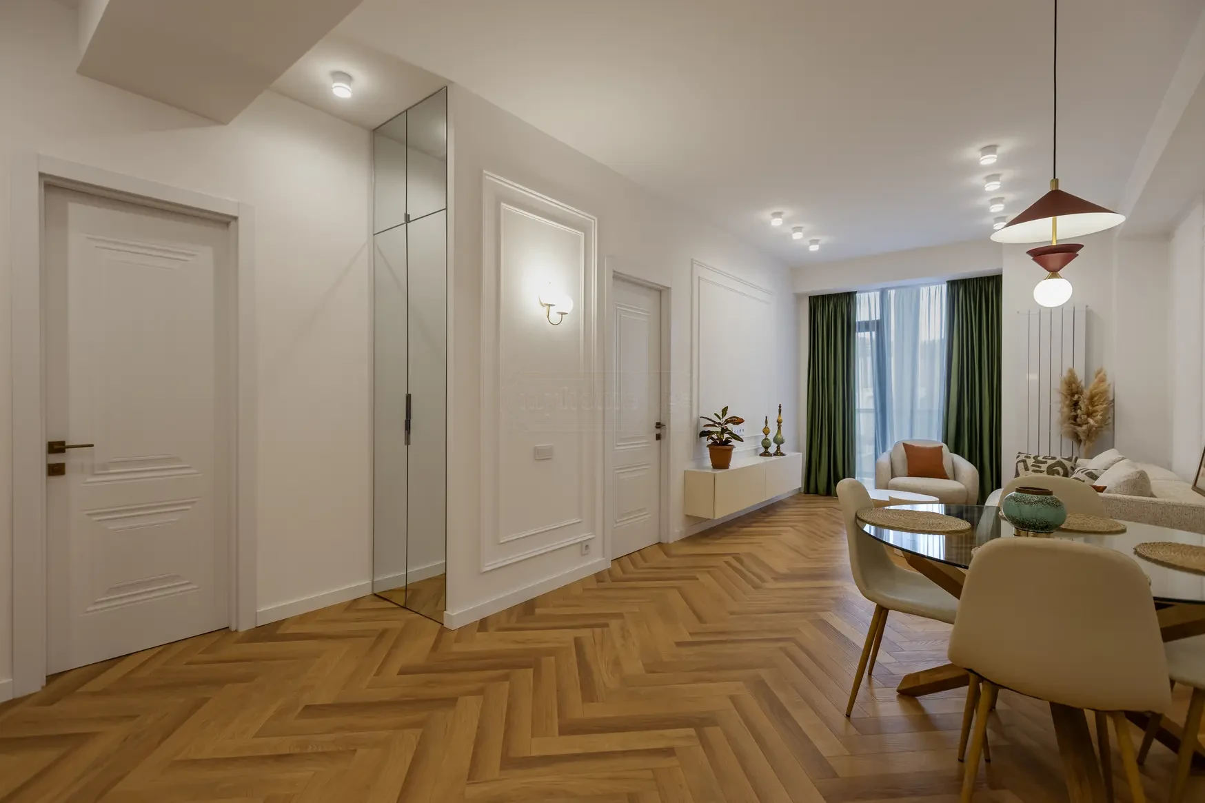 2-room apartment for sale on Politkovskaya Street, Saburtalo, Tbilisi — open living space with moulded walls and dining table
