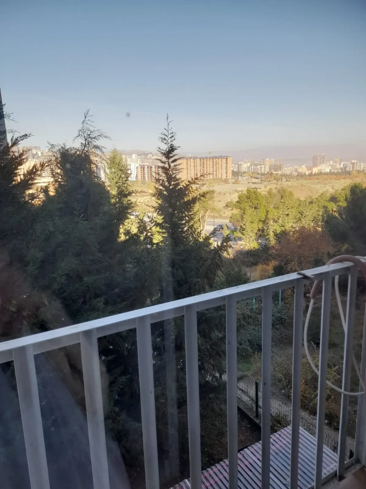 3-room apartment for rent on Tskneti Highway, Bagebi, Tbilisi — balcony view over the trees toward the city